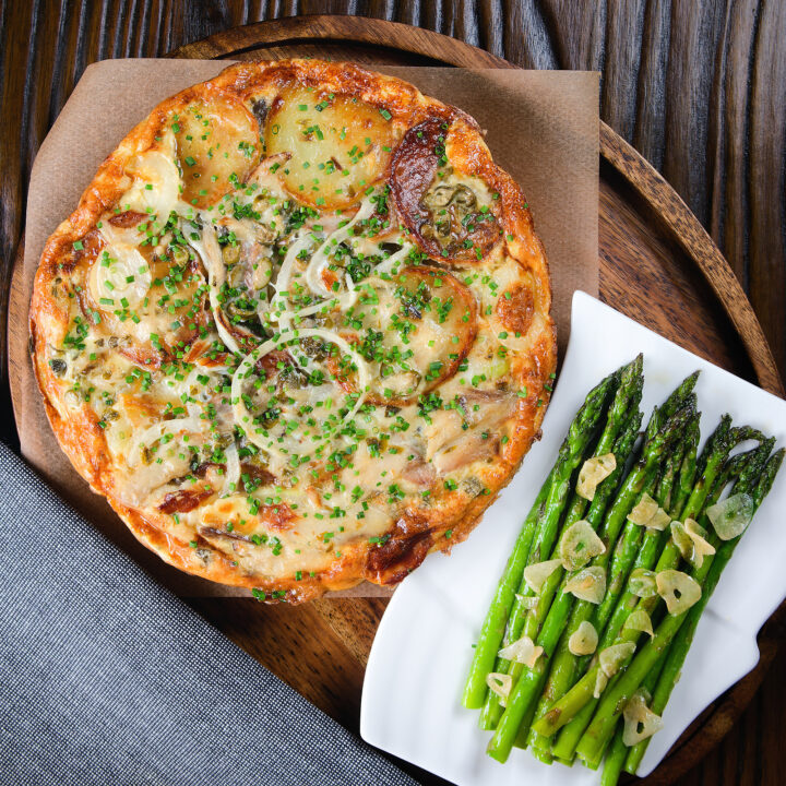 Smoked mackerel potato frittata served with garlic asparagus.