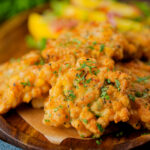 Prawn or shrimp and sweetcorn fritters served with a mango and red onion salad.