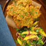 Overhead prawn or shrimp and sweetcorn fritters served with a mango and red onion salad.