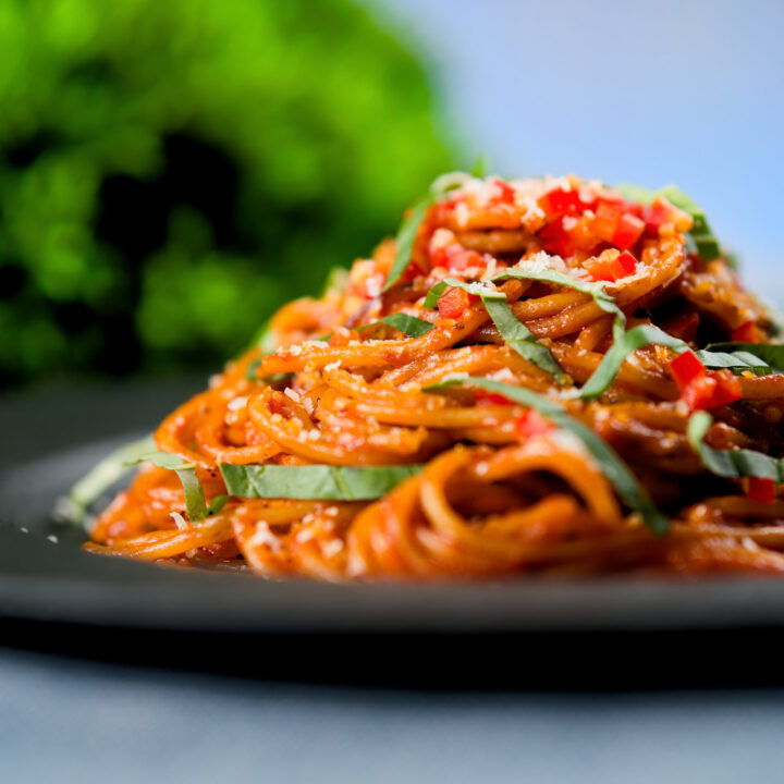 Fried spaghetti all assissina or killers pasta garnished with fresh chilli, basil and parmesan cheese.