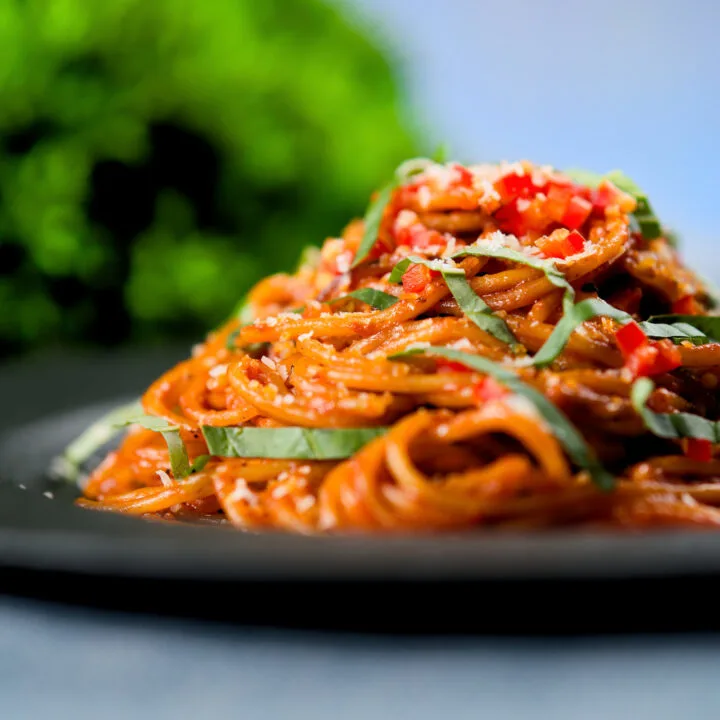 Fried spaghetti all assissina or killers pasta garnished with fresh chilli, basil and parmesan cheese.