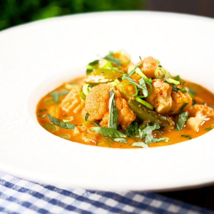 Thai red curry vegetable soup with cauliflower, baby corn and sugar snap peas.