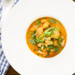 Overhead Thai vegetable curry soup with coconut milk.