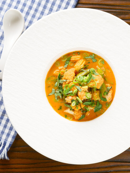 Overhead Thai vegetable curry soup with coconut milk.