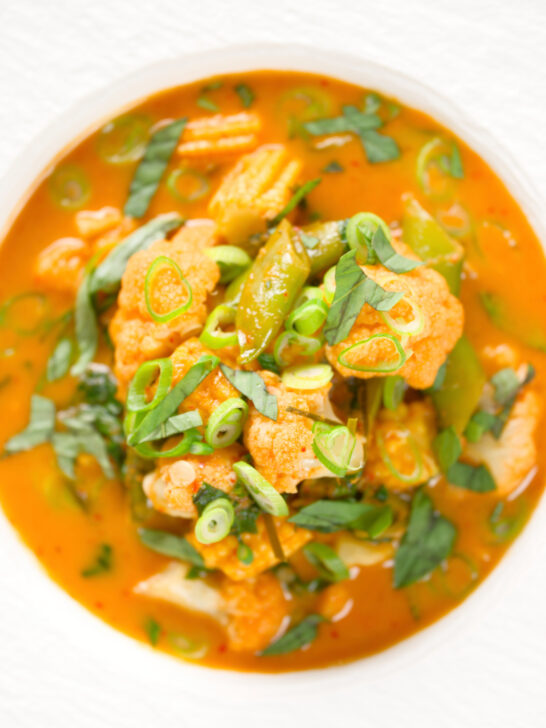 Close-up overhead Thai vegetable curry soup with coconut milk.