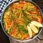 Overhead mixed vegetable paella with fennel and artichokes (Vegan & Vegetarian).