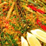 Overhead close-up mixed vegetable paella with fennel and artichokes (Vegan & Vegetarian).