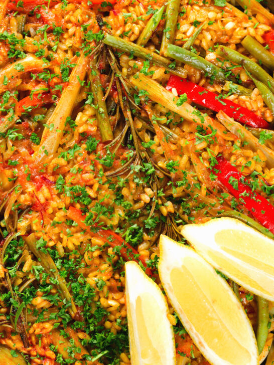 Overhead close-up mixed vegetable paella with fennel and artichokes (Vegan & Vegetarian).