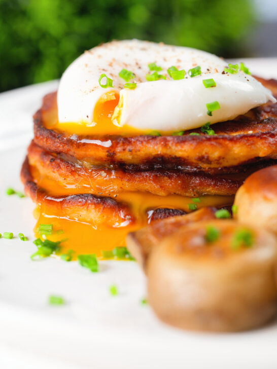 Close-up Irish boxty potato pancakes with poached egg and mushrooms.