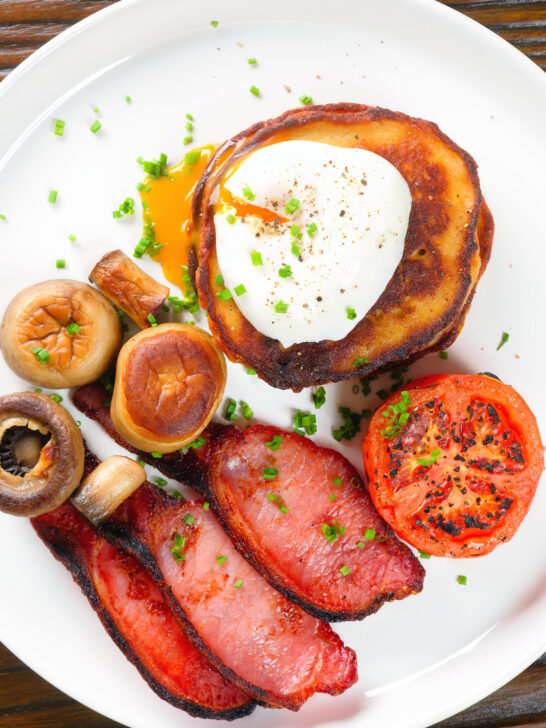 Overhead close-up Irish boxty pancakes with poached egg, bacon tomato and mushrooms.