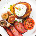 Overhead close-up Irish boxty pancakes with poached egg, bacon tomato and mushrooms.