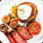 Overhead close-up Irish boxty pancakes with poached egg, bacon tomato and mushrooms.
