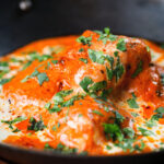 Close-up rich and creamy Indian butter chicken curry or murgh makhani.