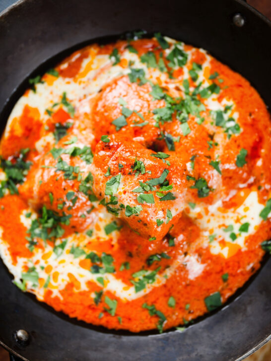 Overhead close-up rich and creamy Indian butter chicken curry or murgh makhani.