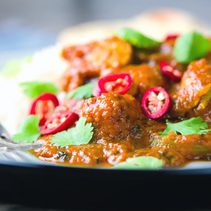 Indian sweet and sour chicken pathia curry served with white rice, chilli and coriander.