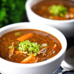 Vegetarian Chinese hot and sour soup with tofu, shiitake mushrooms and spring onions.