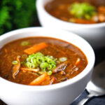 Vegetarian Chinese hot and sour soup with tofu, shiitake mushrooms and spring onions.