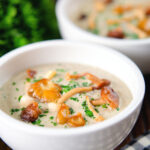 Cream of wild mushroom soup garnished with fried mushrooms.