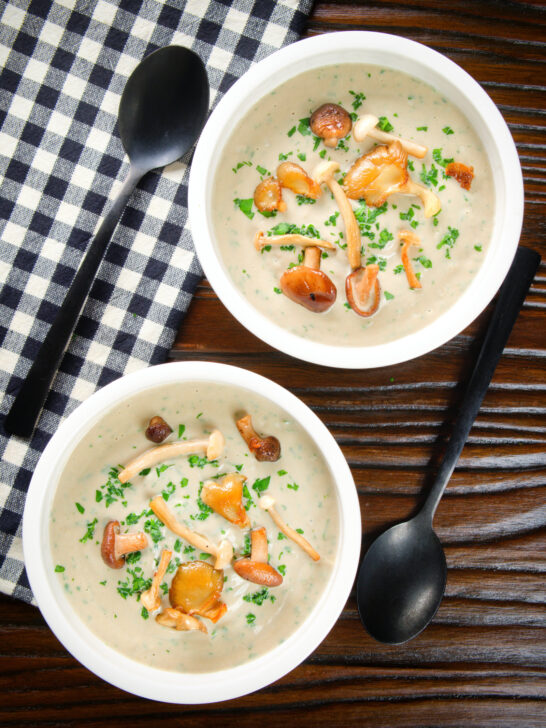 Overhead creamy wild mushroom soup garnished with fried mushrooms.