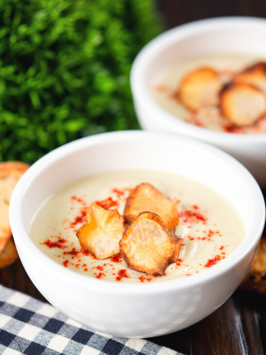 Creamy Jerusalem artichoke soup garnished with paprika and fried sunchoke crisps.