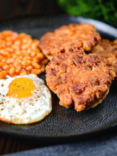 Crispy canned corned beef fritters with fried egg and beans.