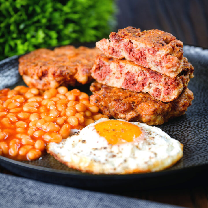 Crispy fried corned beef fritters served with a fried egg and baked beans.