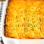 Haggis shepherds pie with clapshot (swede and potato mash) in a baking dish.