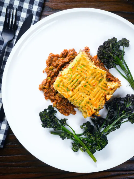 Overhead haggis shepherds pie with clapshot (swede and potato mash) server with broccoli.