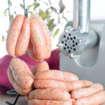 Homemade British linked pork sausages with sage and black pepper.