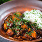 Indian-influenced potato and oxtail curry served with rice.