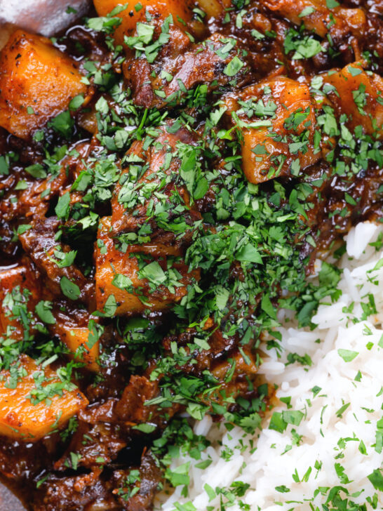 Overhead close-up Indian potato and oxtail curry served with rice.