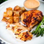 Peri peri spatchcock chicken served with roasted potatoes, asparagus and garlic mayo.