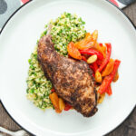Overhead rabbit leg tagine served with herby bulgur wheat.