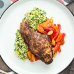 Overhead rabbit leg tagine served with herby bulgur wheat.