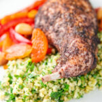 Rabbit leg tagine served with herby bulgur wheat.