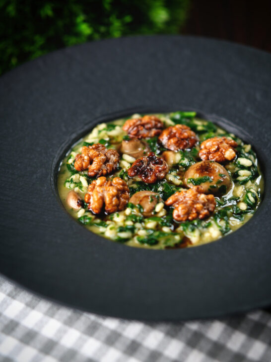 Mushroom and spinach risotto topped with brown butter cooked walnuts.