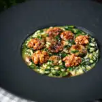 Mushroom and spinach risotto topped with brown butter cooked walnuts.