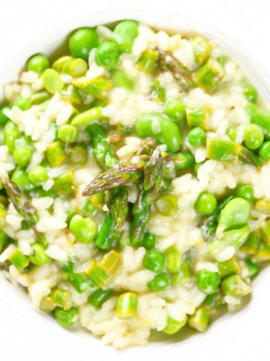 Close-up overhead creamy spring broad bean, pea and asparagus risotto.