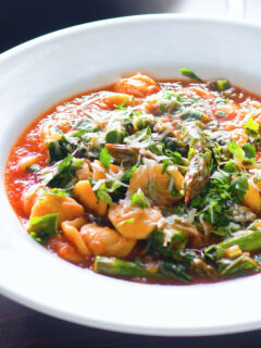 Asparagus and tomato orecchiette pasta soup/stew with wild garlic.