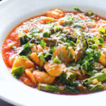 Asparagus and tomato orecchiette pasta soup/stew with wild garlic.