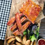 Overhead apricot jam and mustard glazed bacon ribs served with air fryer potato wedges.