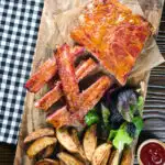 Overhead apricot jam and mustard glazed bacon ribs served with air fryer potato wedges.