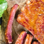 Overhead close-up apricot jam and mustard glazed bacon ribs.