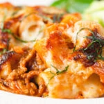 Close-up cheesy baked pasta al forno with a beef, pork and tomato sauce.