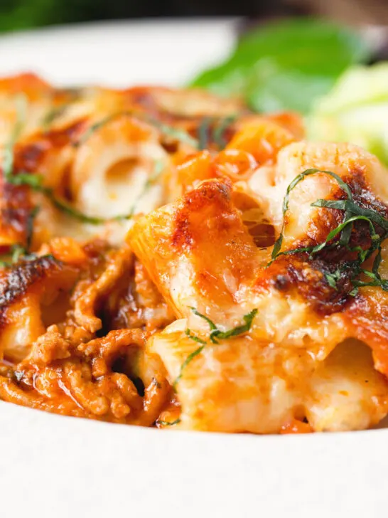 Close-up cheesy baked pasta al forno with a beef, pork and tomato sauce.