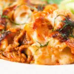 Close-up cheesy baked pasta al forno with a beef, pork and tomato sauce.
