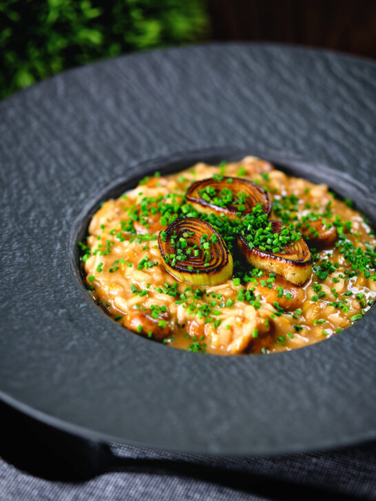 Creamy balsamic leek and mushroom risotto topped with seared leek rings.