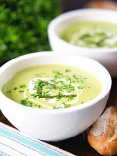 Cream of asparagus soup garnished with snipped chives, served with cheesy bread.