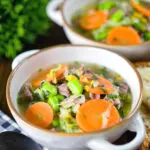 Hotch potch soup or harvest broth with lamb and vegetables with buttered bread.