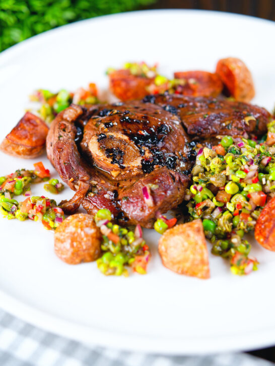 Pan-fried leg of lamb steaks served with pea "salsa" and fried new potatoes.